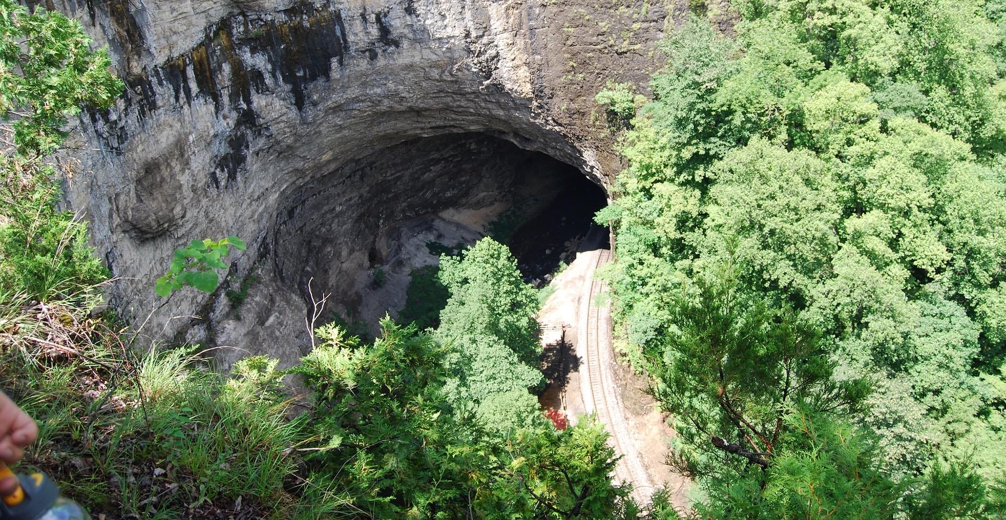 The 850 feet long and 10 stories high Natural Tunnel in Duffield, Virginia, with a railroad track running through it.