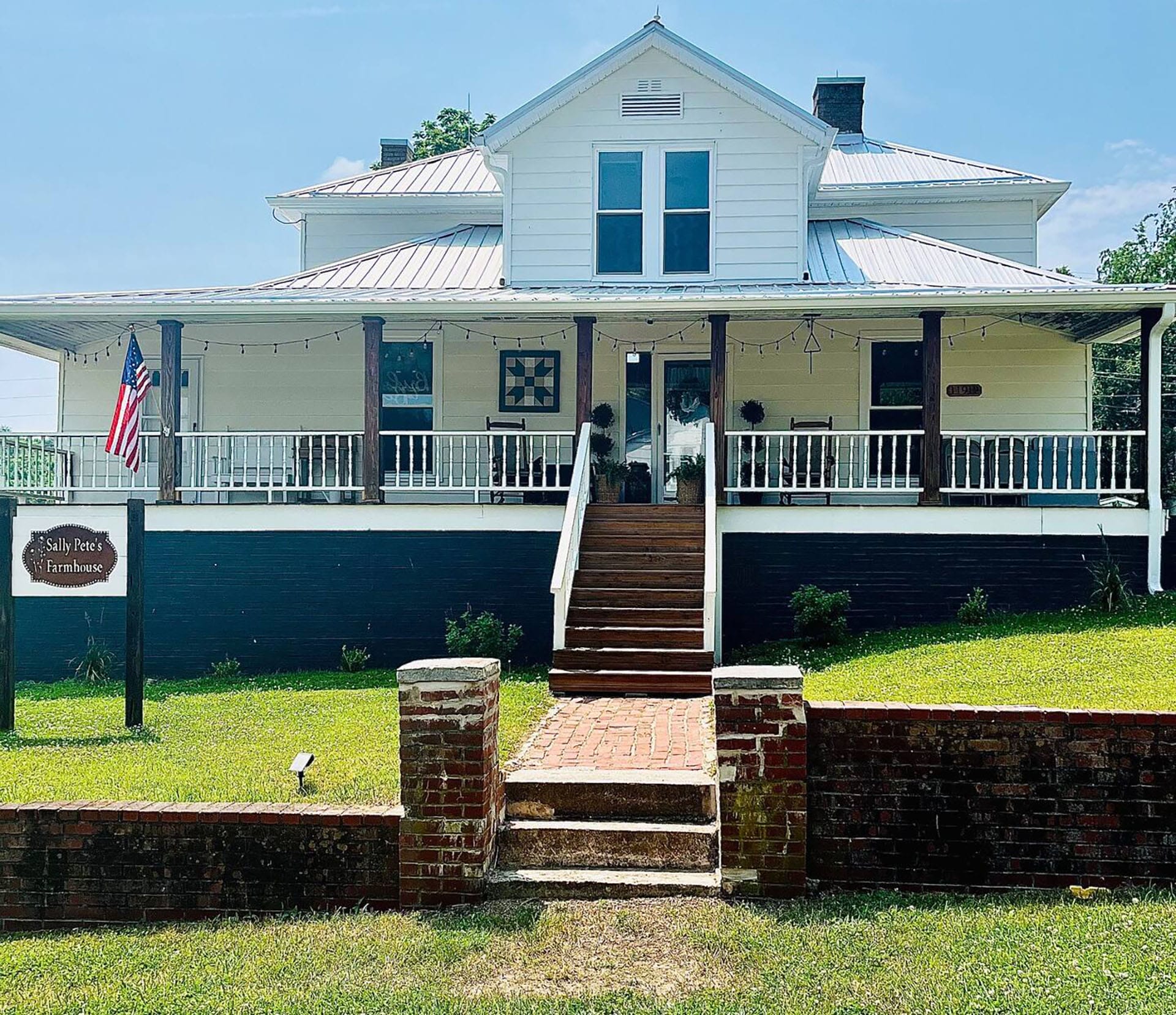 The exterior of Sally Pete's Farmhouse offers a huge front porch for guests to sit outside and enjoy.